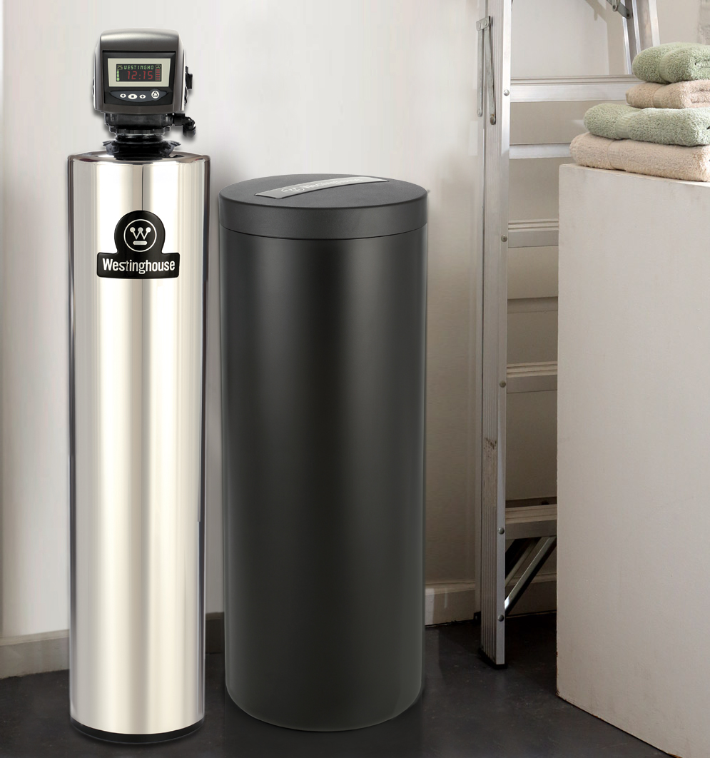 Celestial Solar – Water Softener Celestial Solar & Water Systems silver stainless water softener with a dark gray tank and Westinghouse control head, in a utility area with towels and shelving